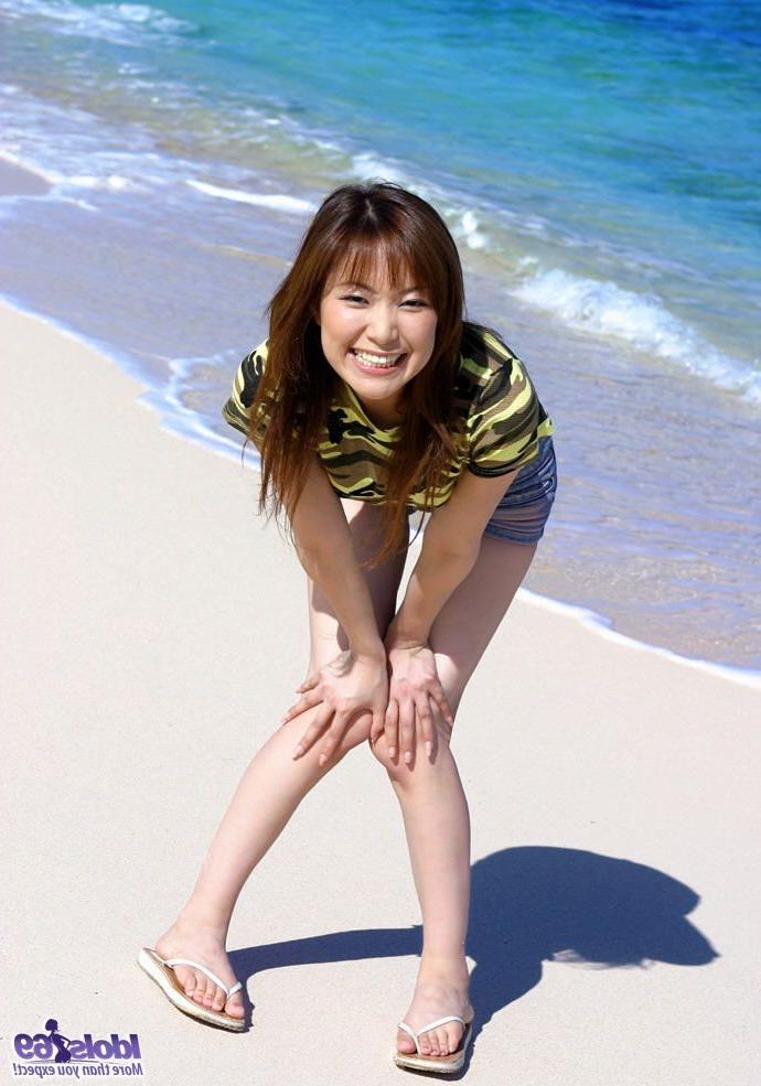 15P Petite Japanese girl with tiny shorts strips naked on the beach