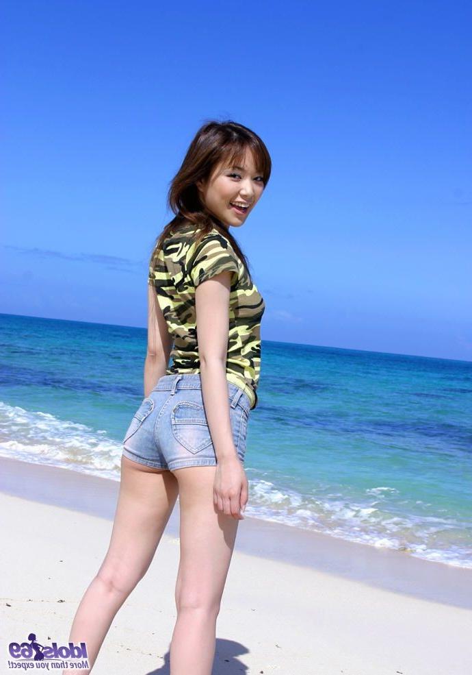 15P Petite Japanese girl with tiny shorts strips naked on the beach