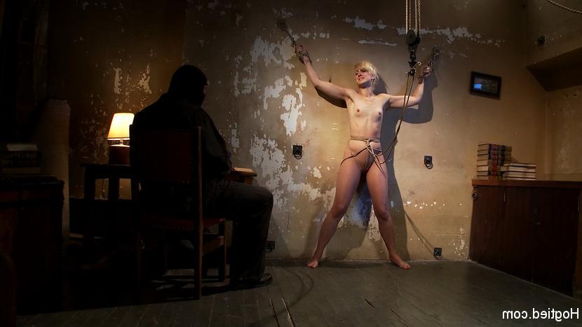 15P Tall long legged blond is held in a creepy room by masked man. She's bound to wa