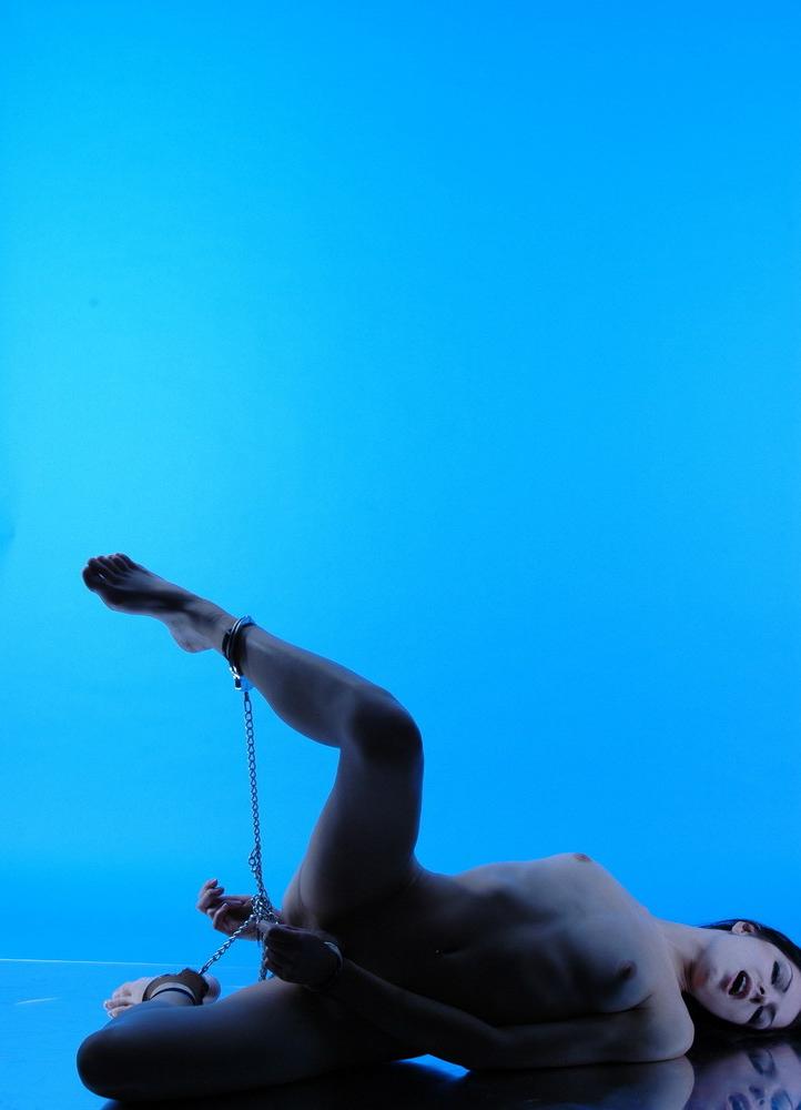 15P Totally nude teen brunette chained to ankles.