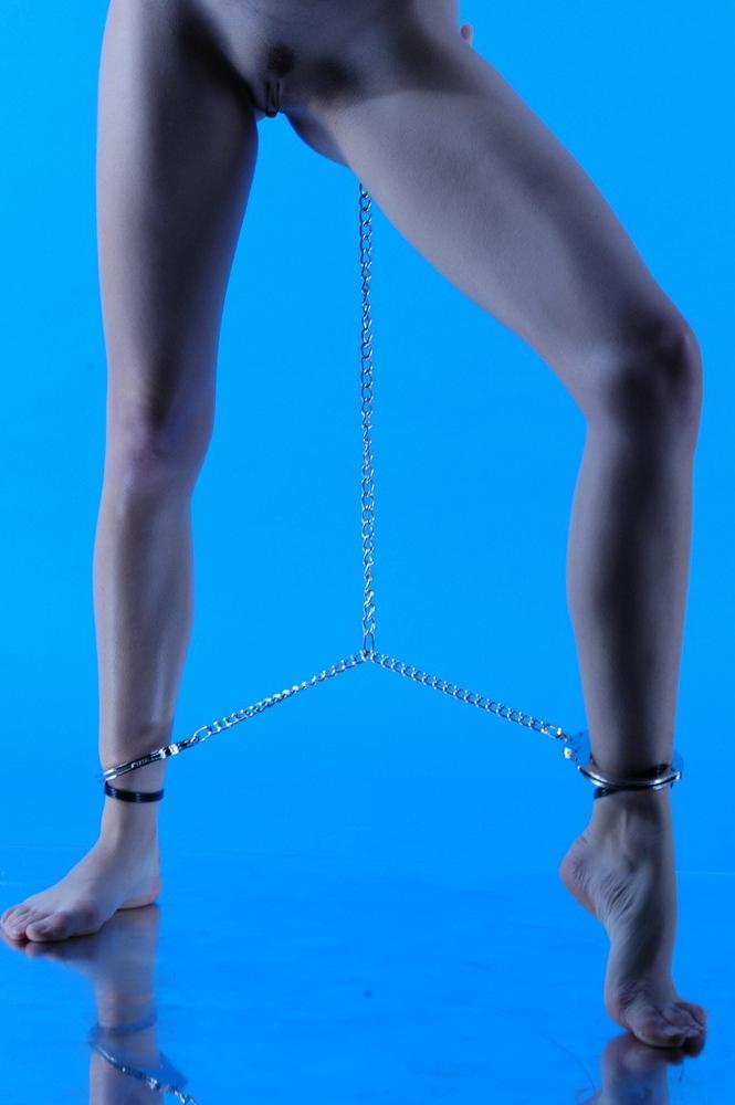 15P Totally nude teen brunette chained to ankles.