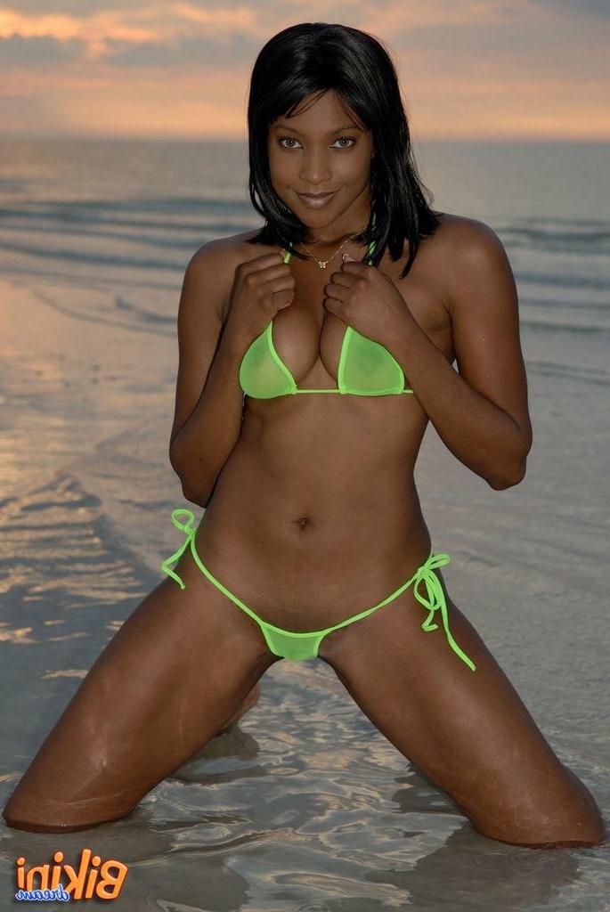 16P Black babe in a thong bikini on the beach