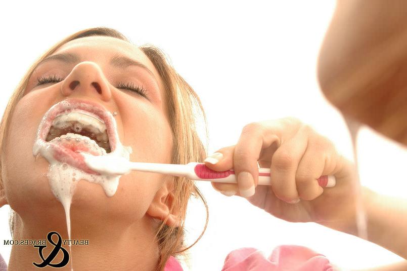 16P Babe in shiny wet metal mouth braces sloppily brushing her teeth