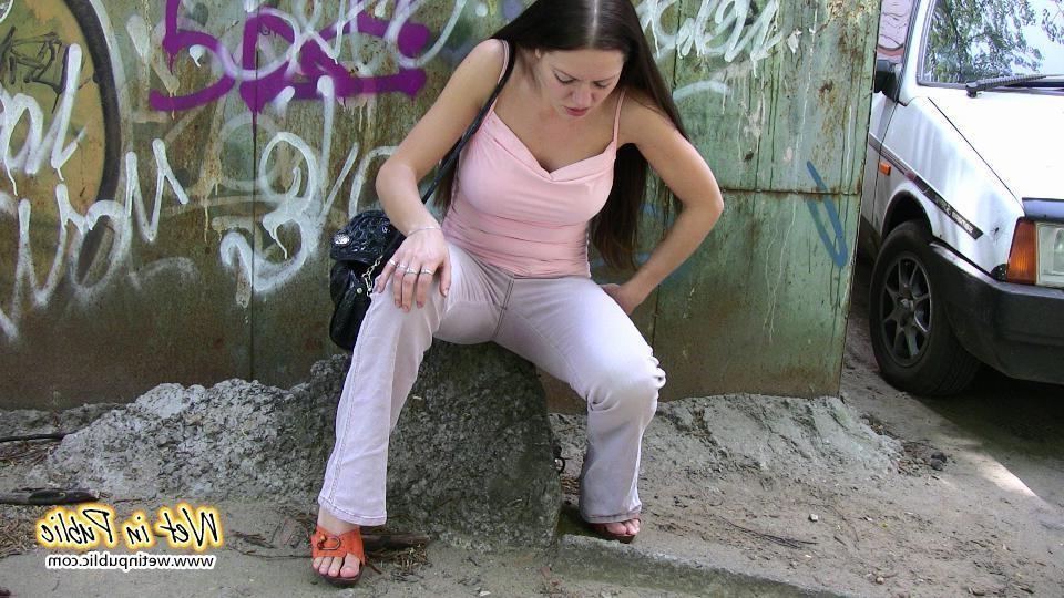 16P Brunette wets her pants and flashes ass while changing on the street