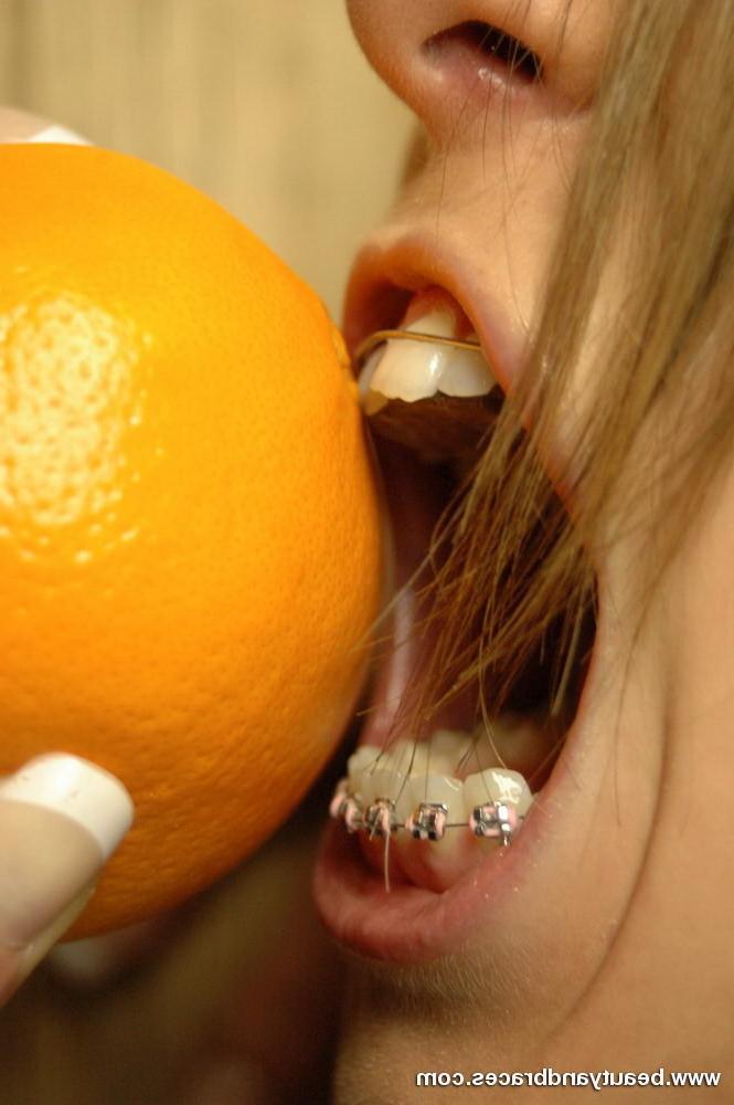 16P Blonde teen with braces makes a mess devouring an orange
