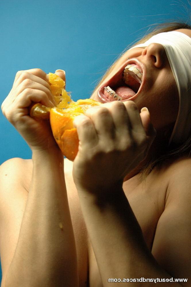 16P Blonde teen with braces makes a mess devouring an orange
