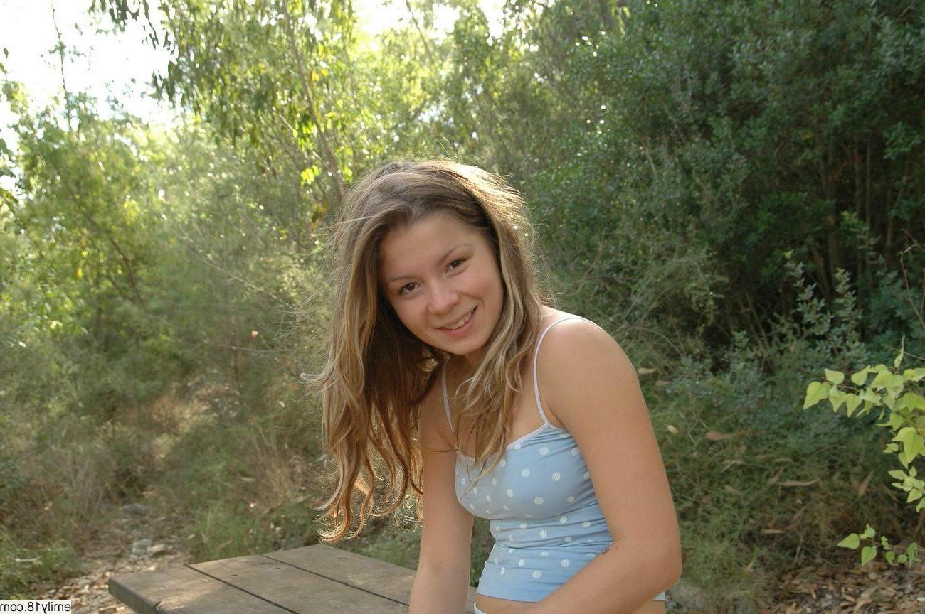 16P Pretty brunette teen girl camping in woods