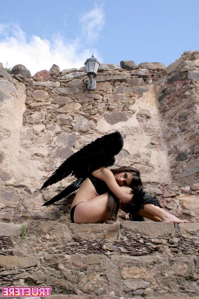 16P Teen girl in angel wings outside