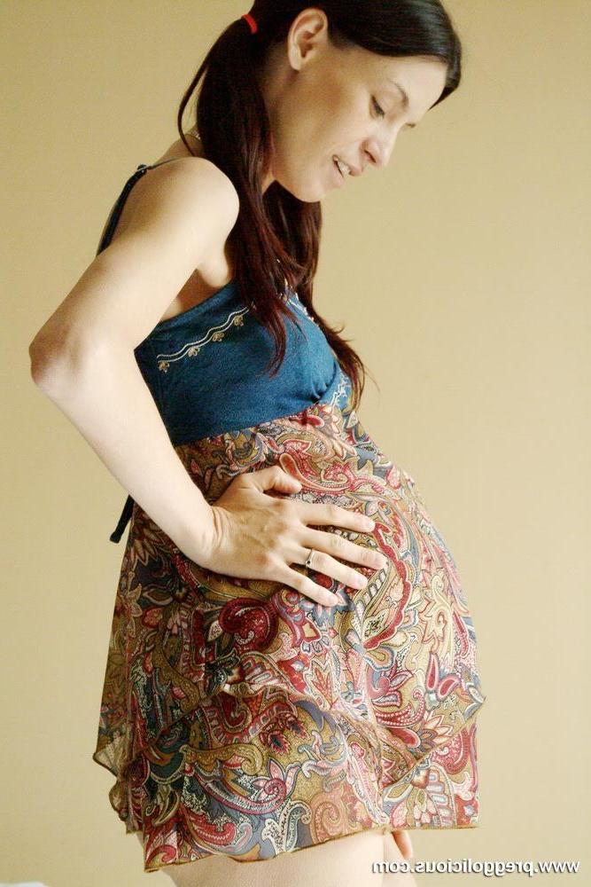16P Beautiful pregnant brunette strips and poses doggy style