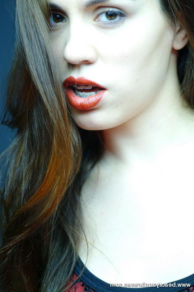 16P Cute brunette teen with braces stretches her mouth wide open