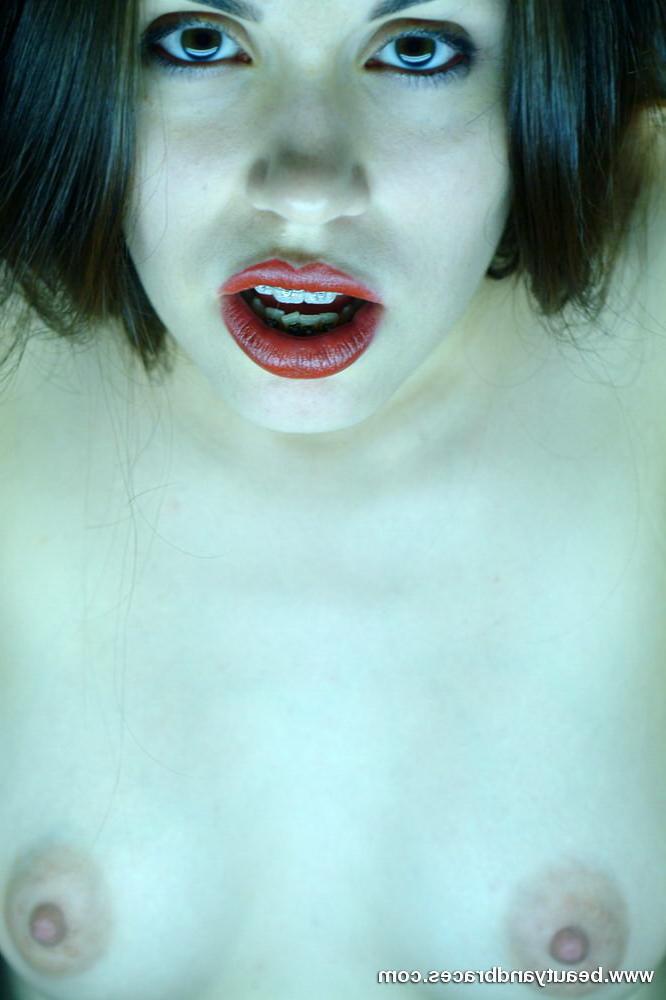16P Cute brunette teen with braces stretches her mouth wide open