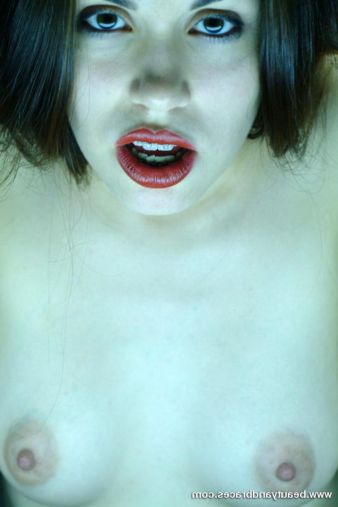 16P Cute brunette teen with braces stretches her mouth wide open