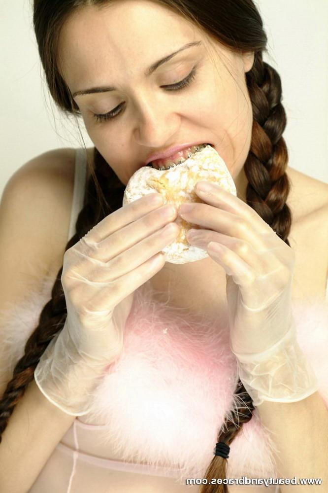 16P Pigtailed teen with braces stuffs a donut in her sexy mouth