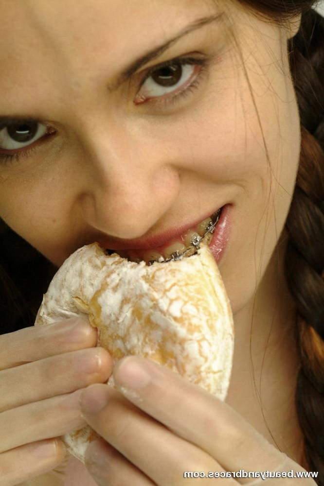 16P Pigtailed teen with braces stuffs a donut in her sexy mouth