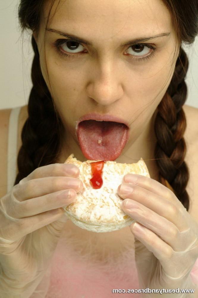 16P Pigtailed teen with braces stuffs a donut in her sexy mouth