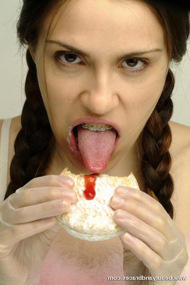 16P Pigtailed teen with braces stuffs a donut in her sexy mouth