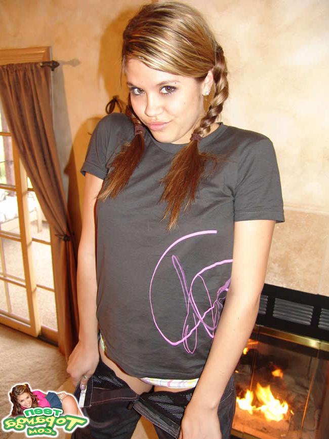 16P Brunette teen with braces posing by the fireplace