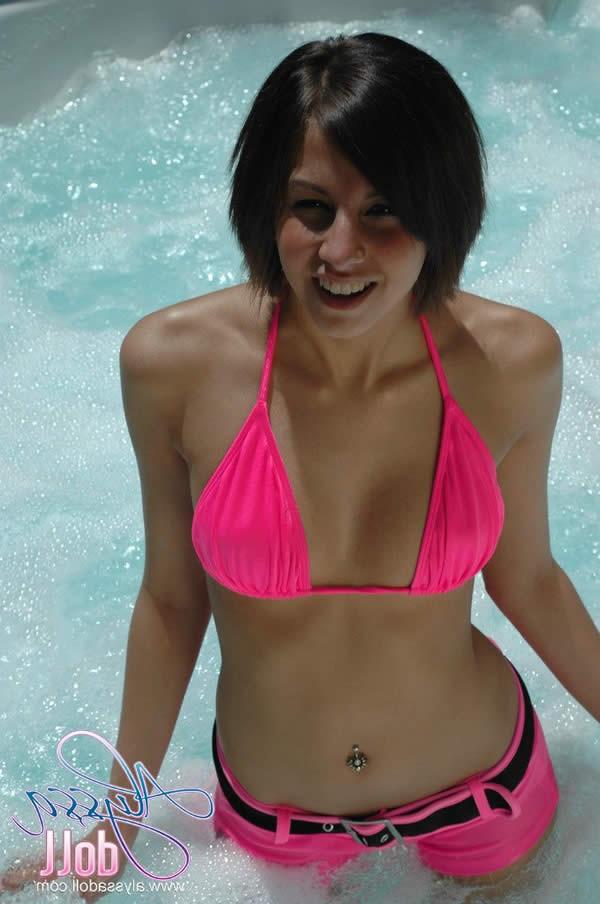 15P Brunette teen splashes and strips in the hottub