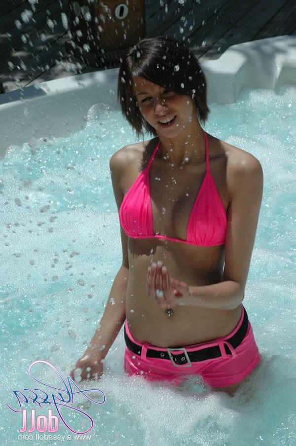 15P Brunette teen splashes and strips in the hottub