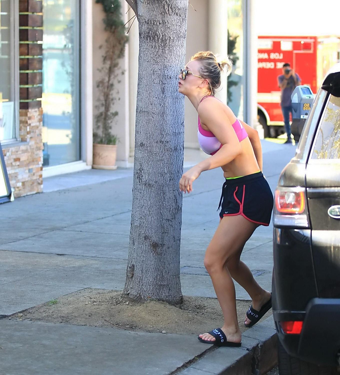 16P Kaley Cuoco showing pokies in a sports bra and shorts