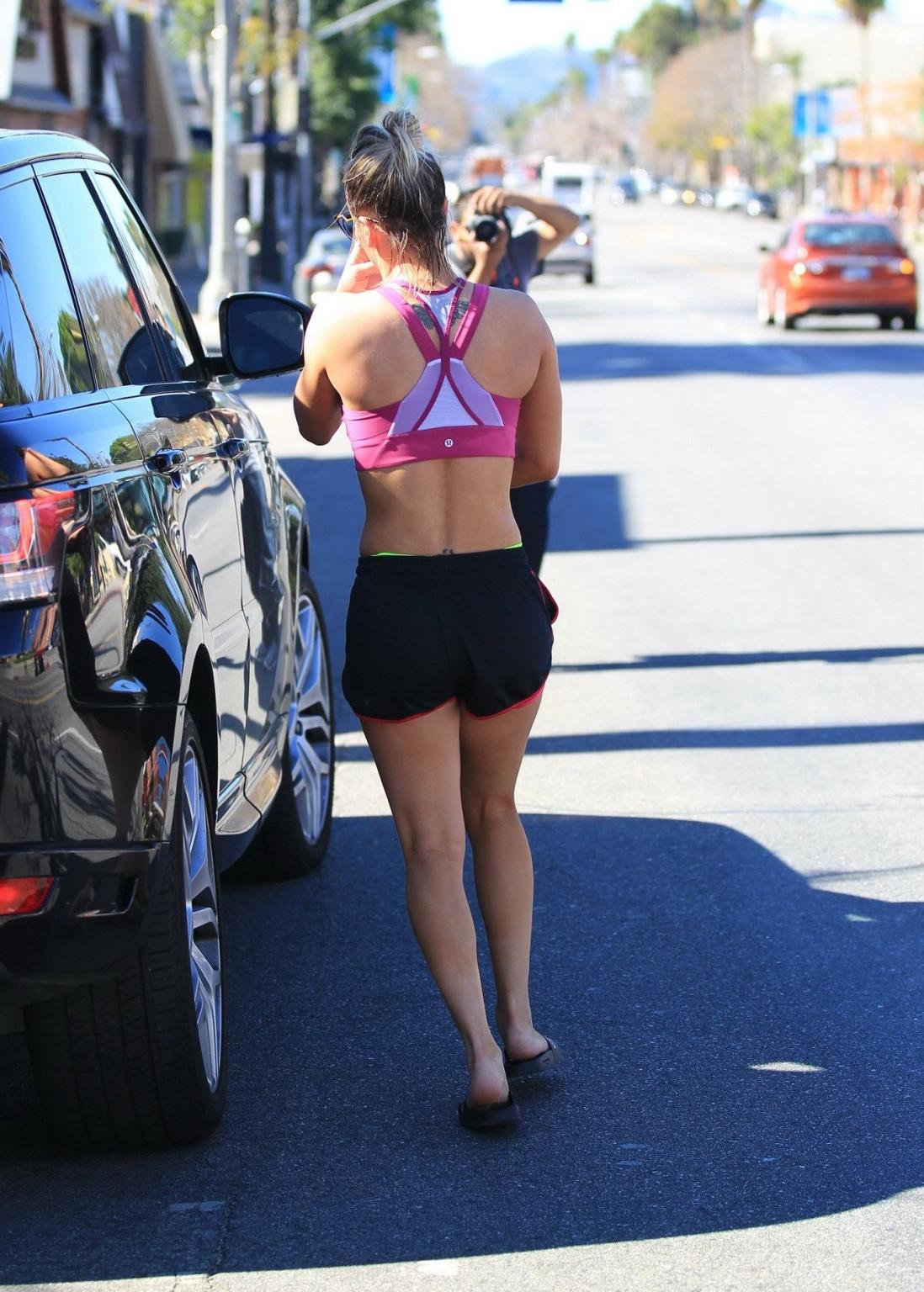 16P Kaley Cuoco showing pokies in a sports bra and shorts