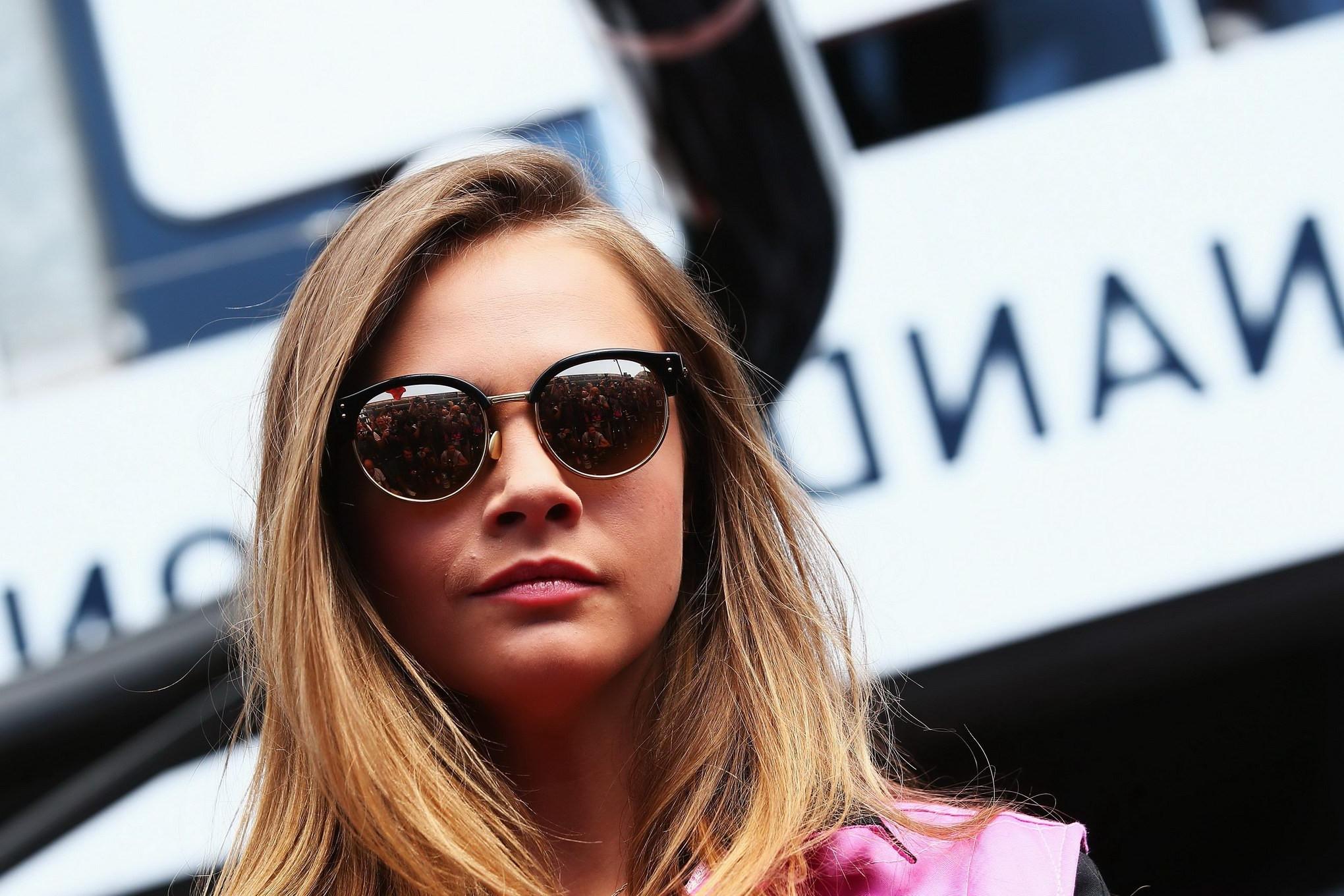 16P Cara Delevingne bra peak wearing an auto racing suit at McLaren Honda pitlane ph