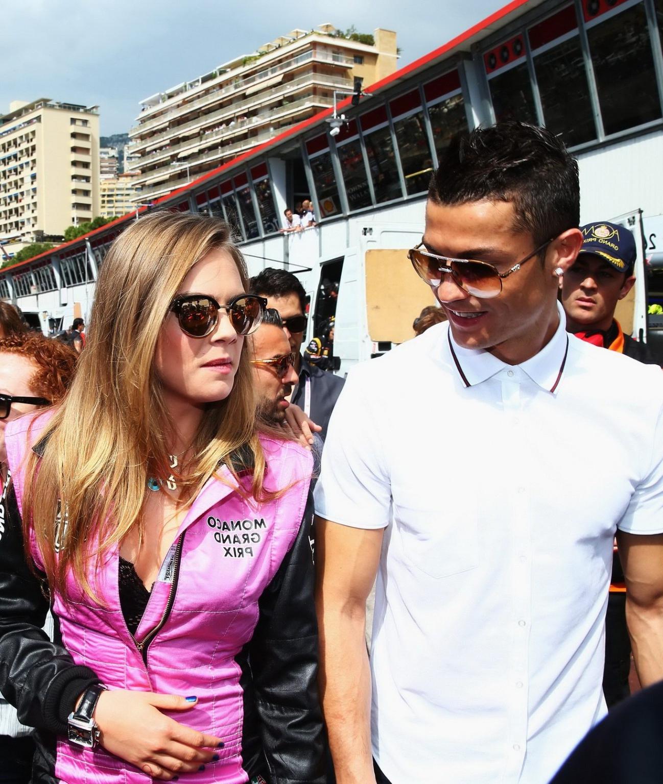 16P Cara Delevingne bra peak wearing an auto racing suit at McLaren Honda pitlane ph