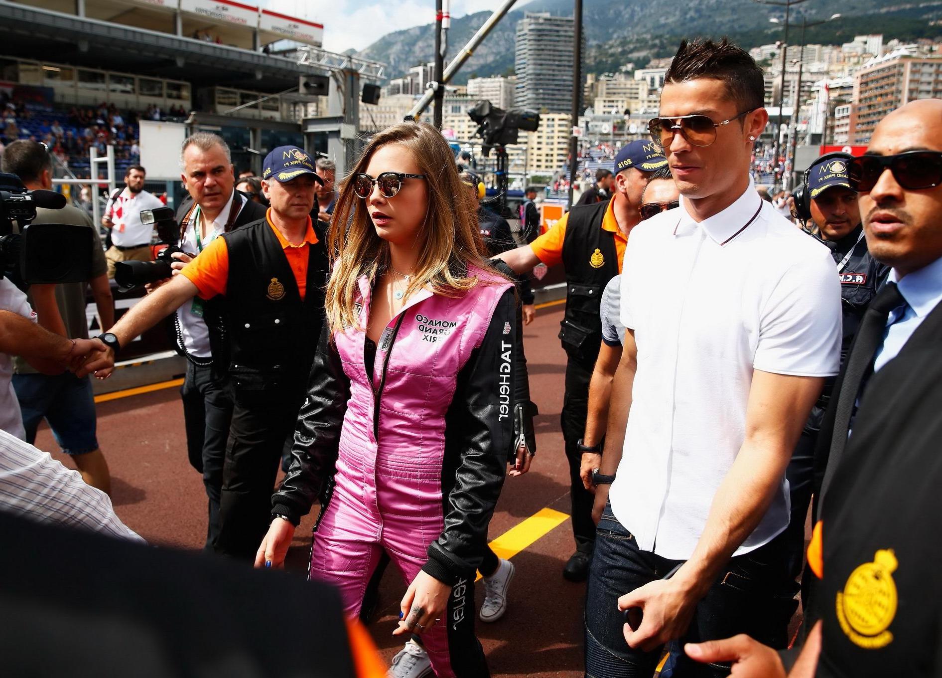 16P Cara Delevingne bra peak wearing an auto racing suit at McLaren Honda pitlane ph