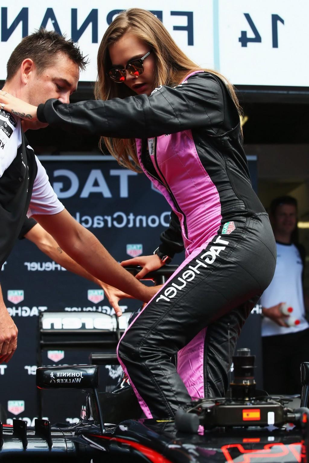 16P Cara Delevingne bra peak wearing an auto racing suit at McLaren Honda pitlane ph