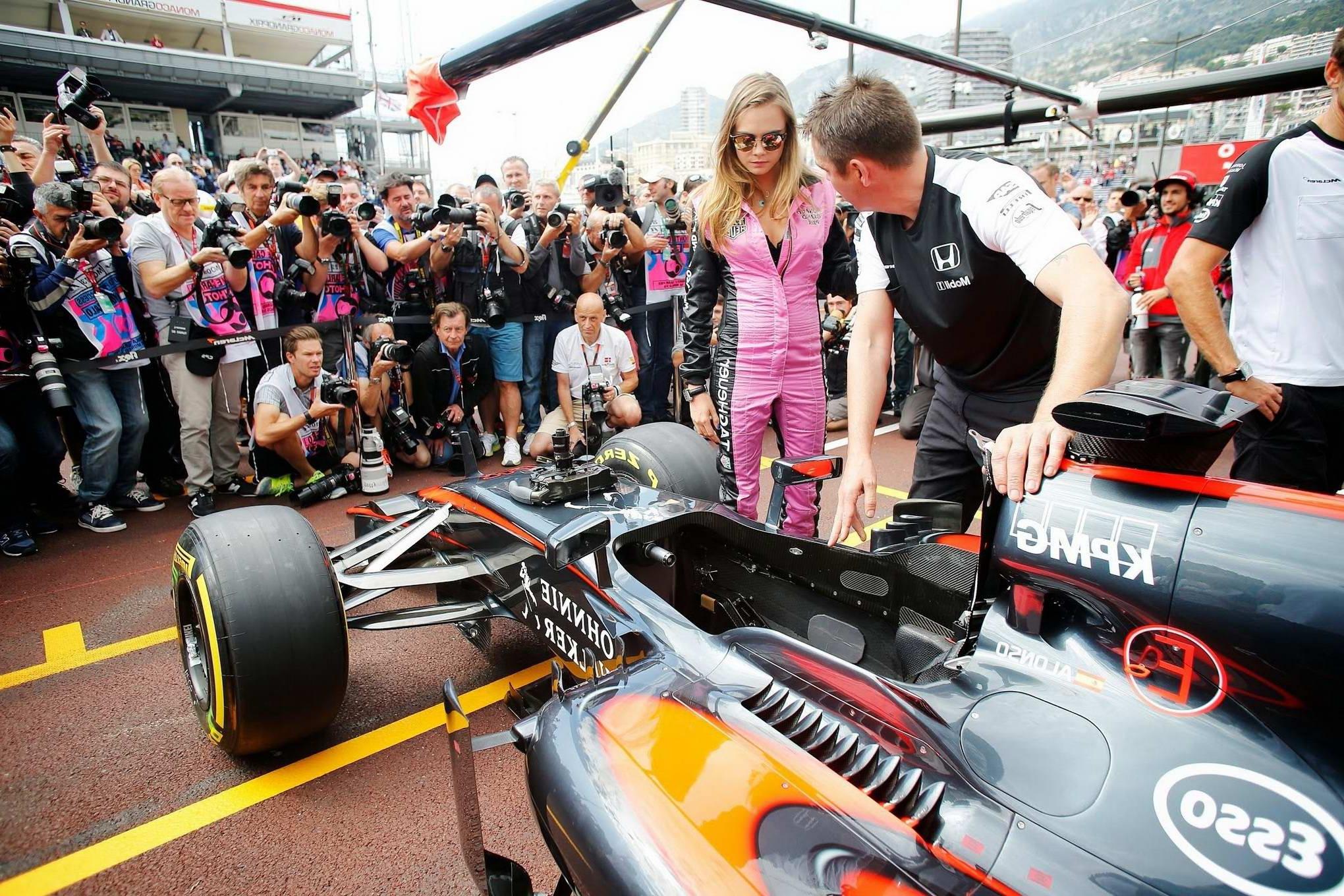16P Cara Delevingne bra peak wearing an auto racing suit at McLaren Honda pitlane ph