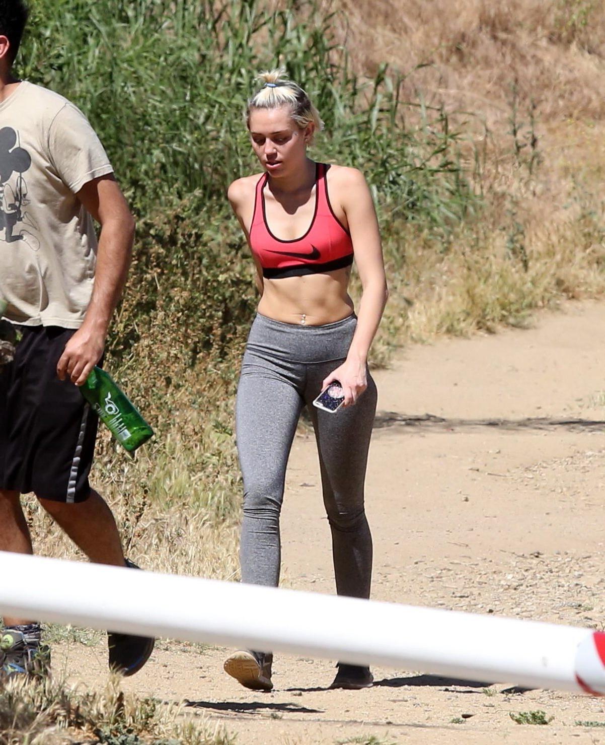 16P Miley Cyrus in sports bra  tights hiking with friends in LA
