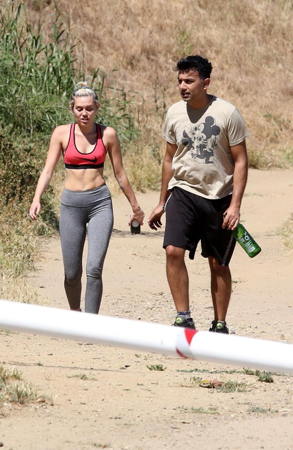 16P Miley Cyrus in sports bra  tights hiking with friends in LA