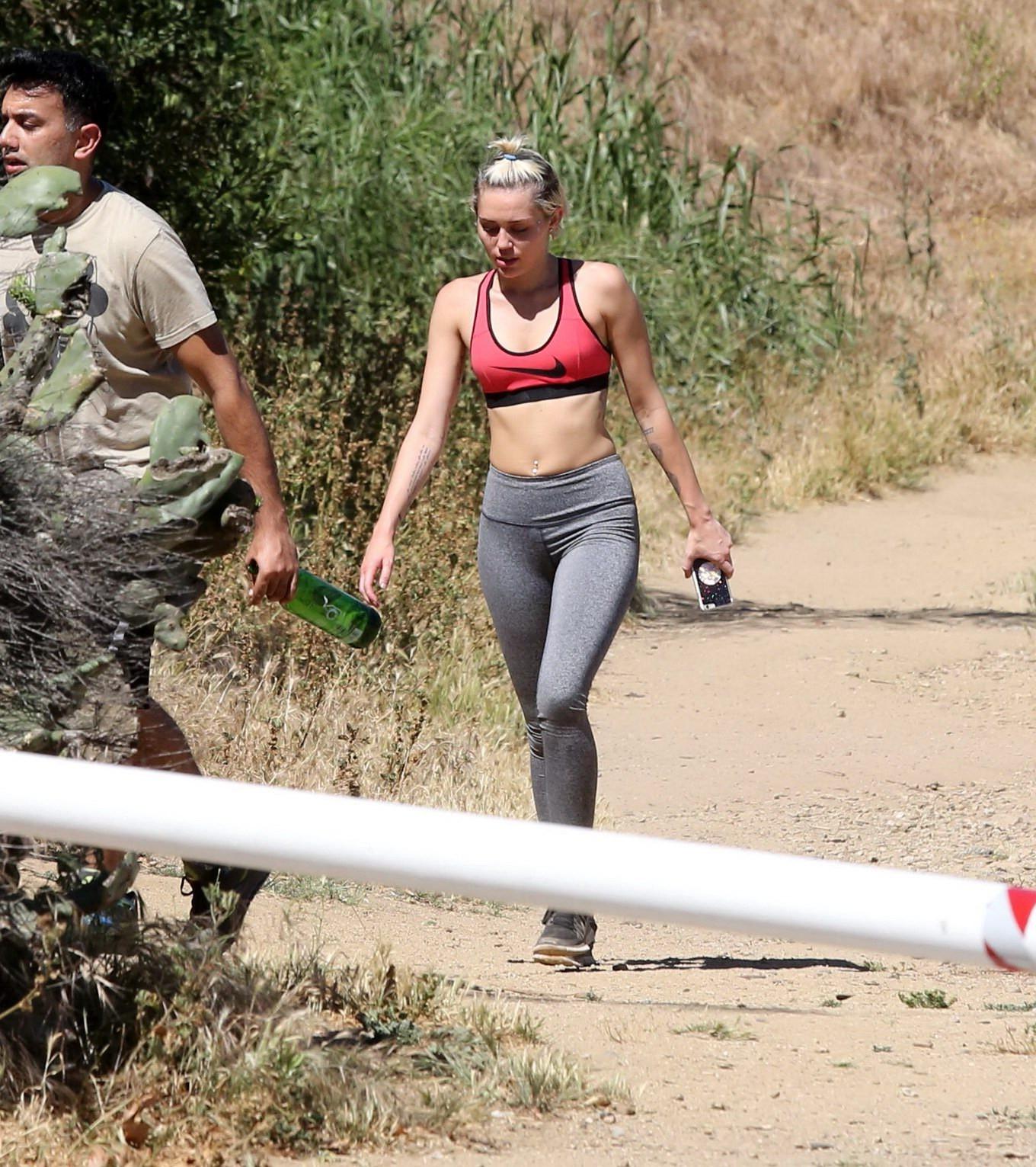 16P Miley Cyrus in sports bra  tights hiking with friends in LA