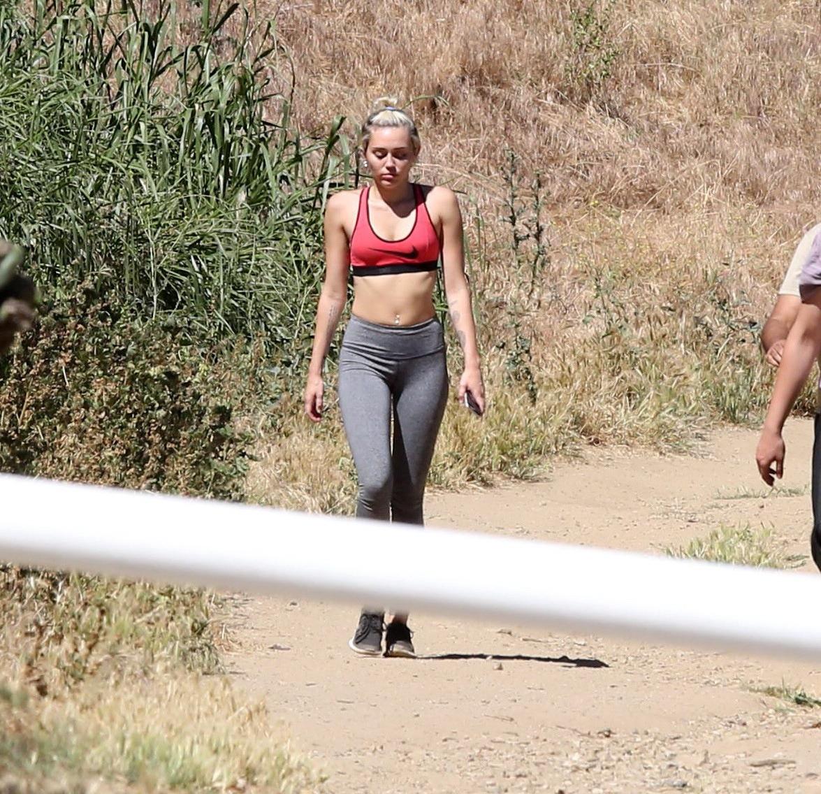 16P Miley Cyrus in sports bra  tights hiking with friends in LA