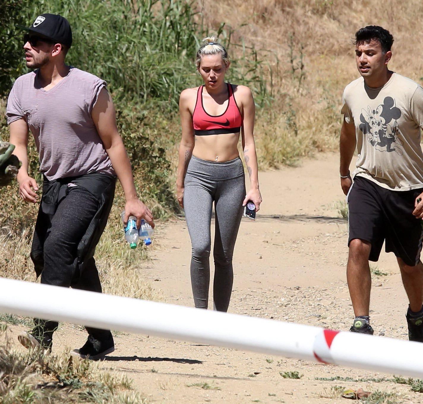 16P Miley Cyrus in sports bra  tights hiking with friends in LA
