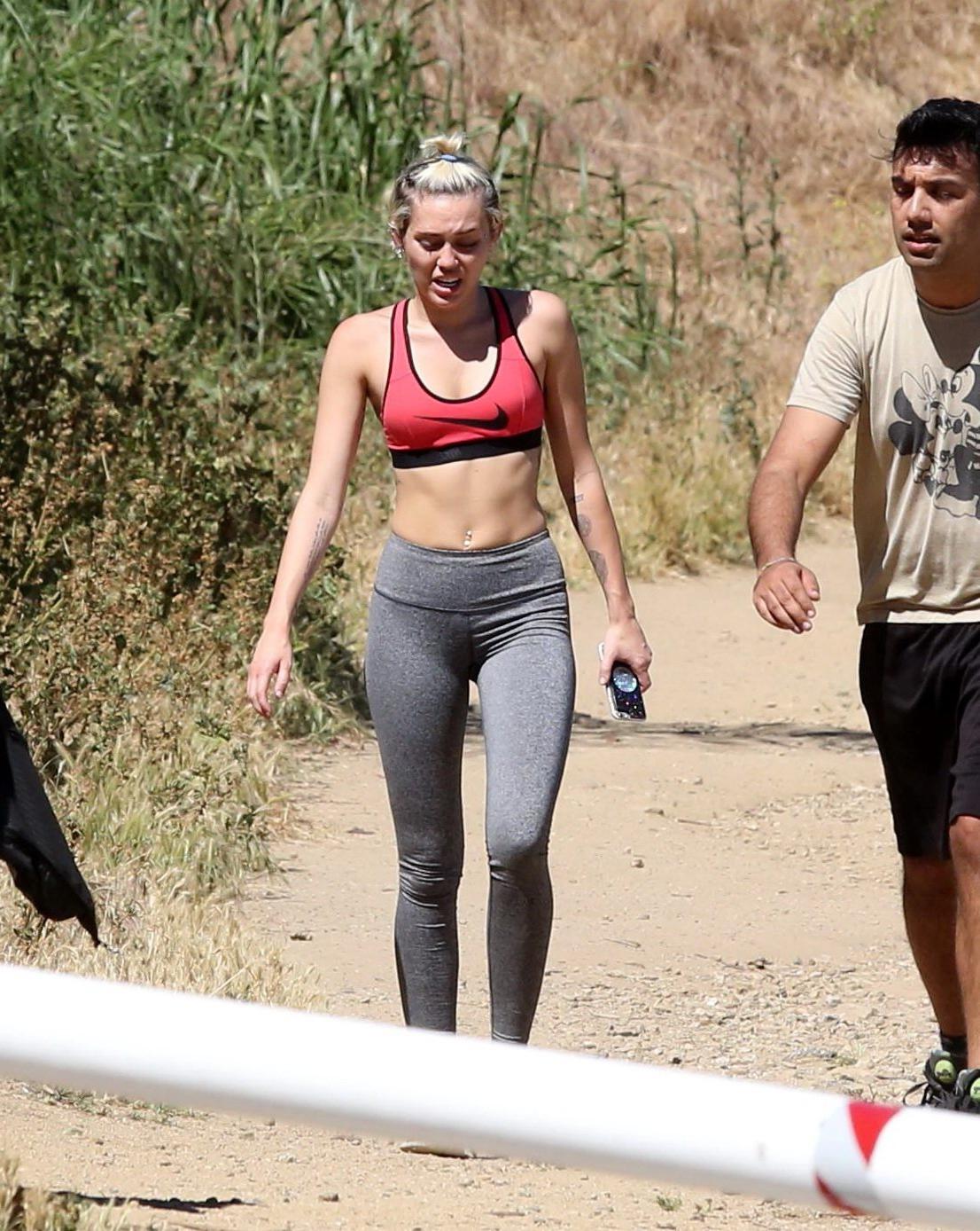 16P Miley Cyrus in sports bra  tights hiking with friends in LA