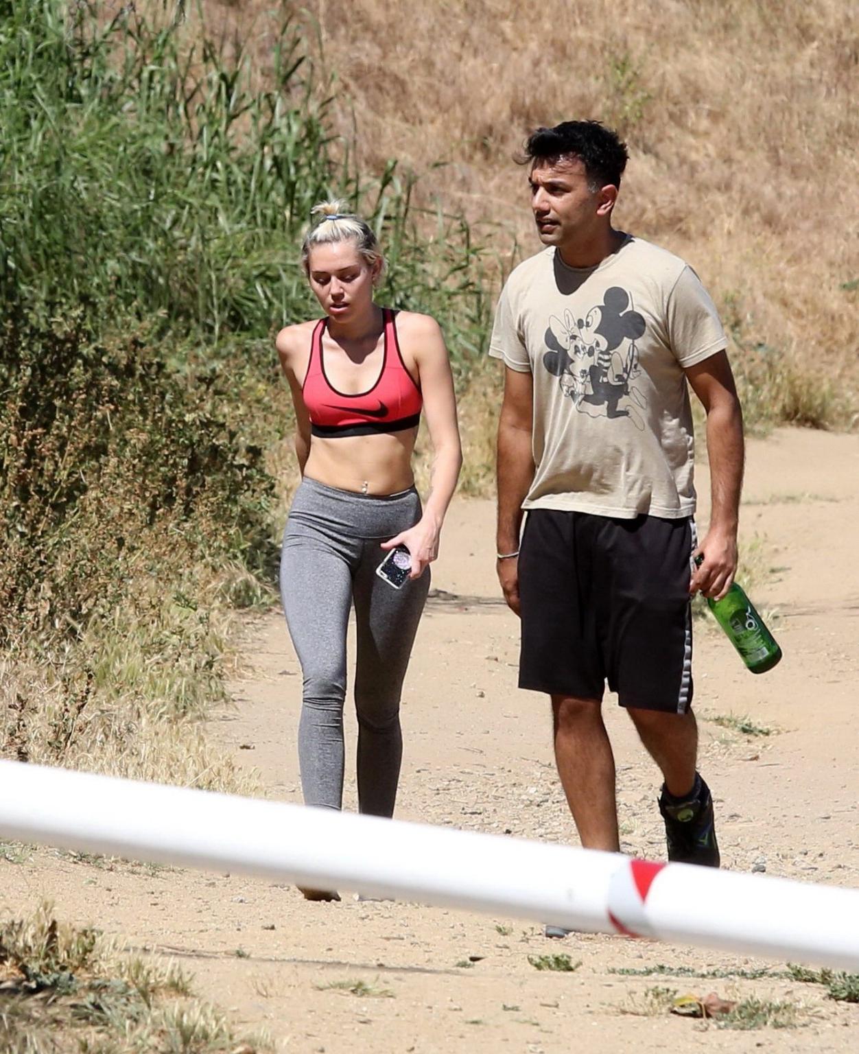 16P Miley Cyrus in sports bra  tights hiking with friends in LA