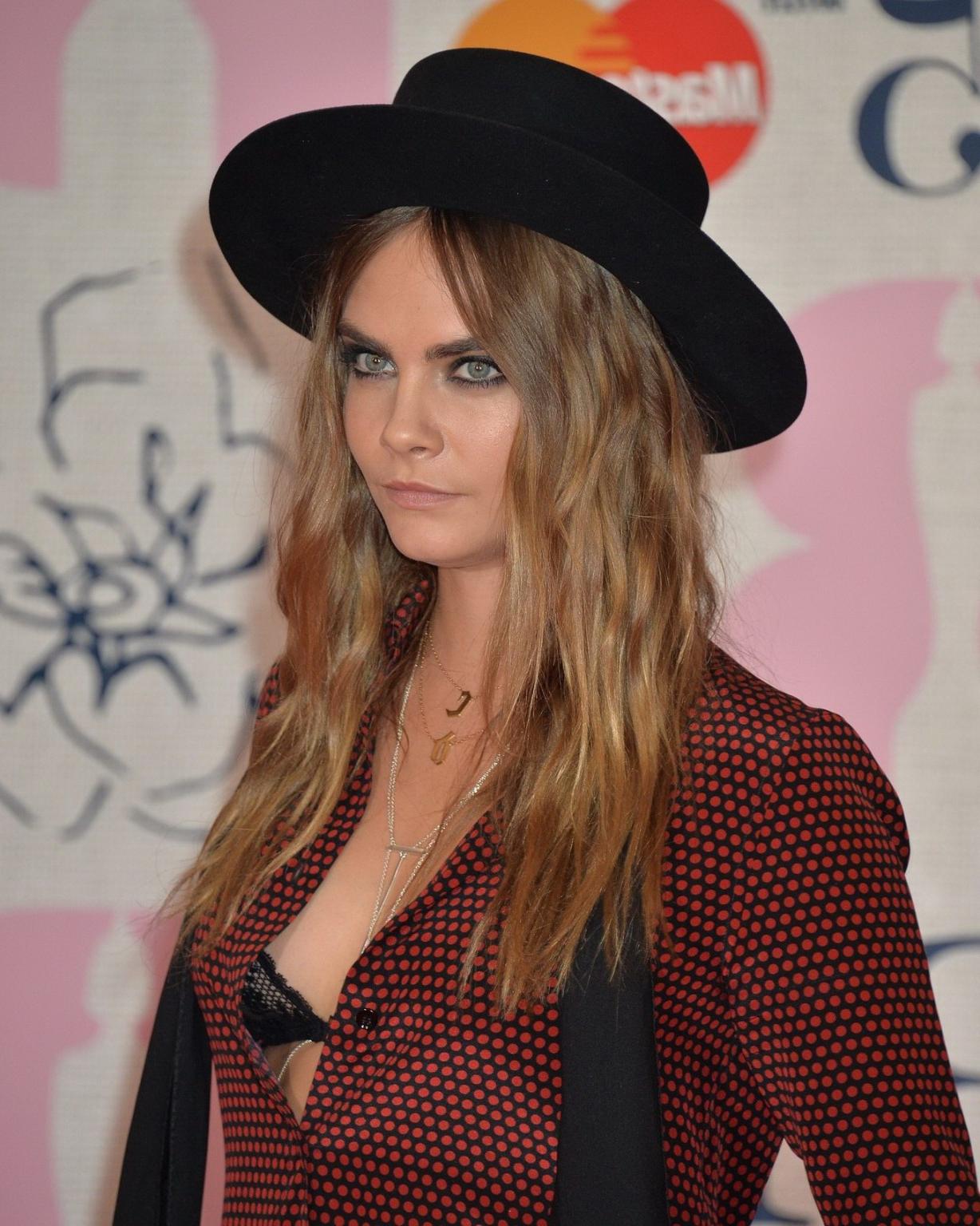 16P Cara Delevingne bra peek at the Brit Awards in London