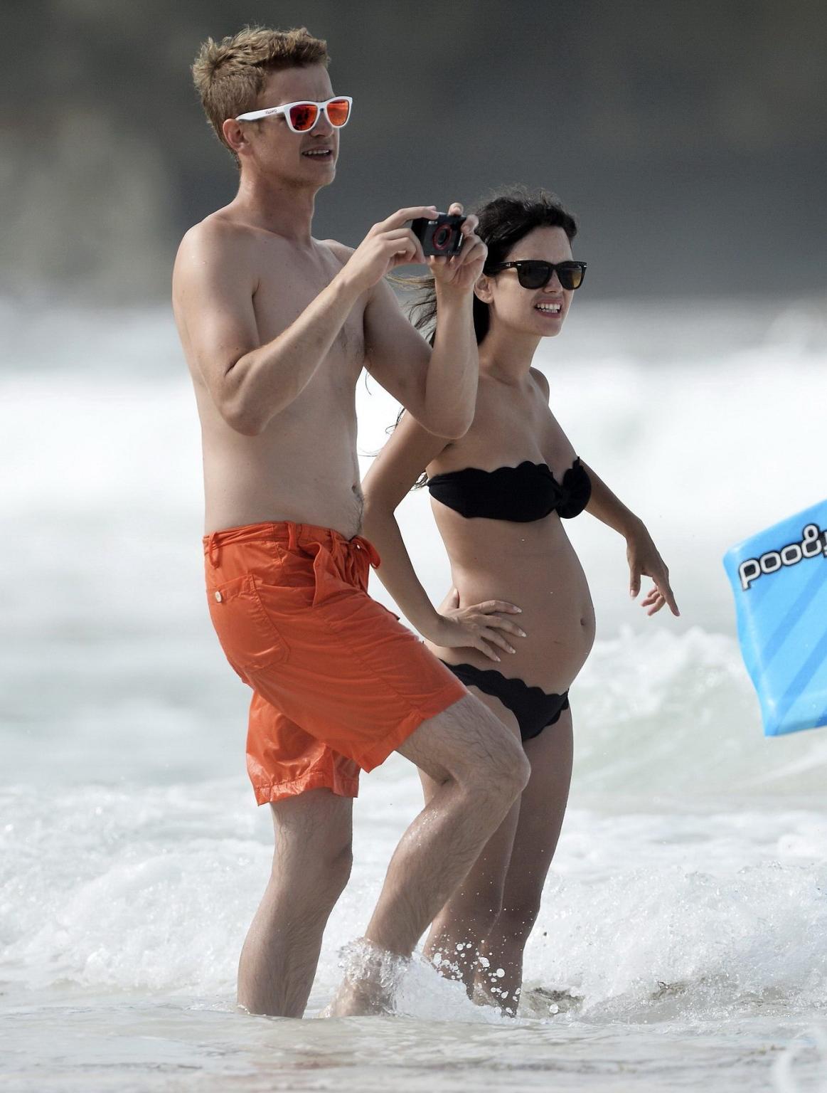 16P Rachel Bilson pregnant wearing a strapless black bikini on a beach in Barbados