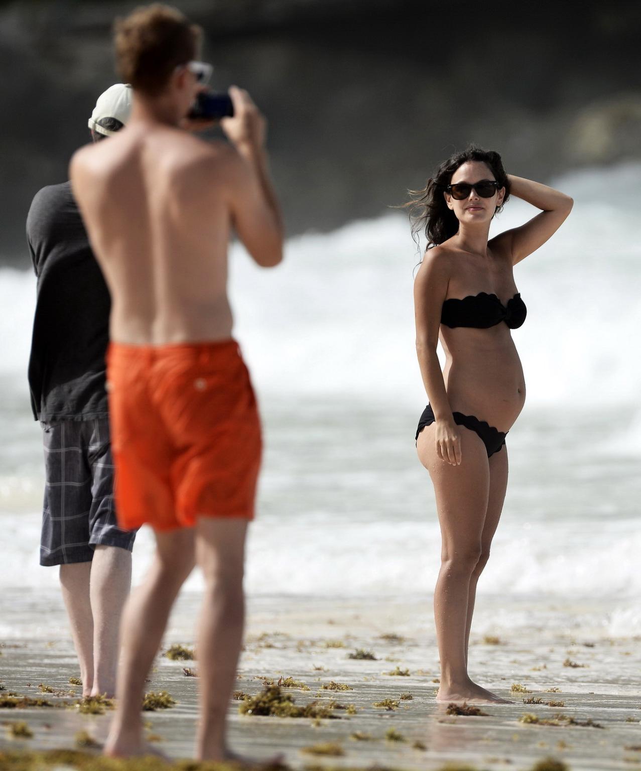 16P Rachel Bilson pregnant wearing a strapless black bikini on a beach in Barbados