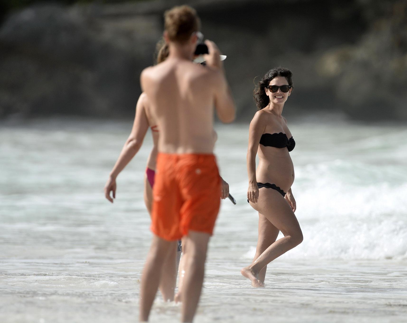 16P Rachel Bilson pregnant wearing a strapless black bikini on a beach in Barbados