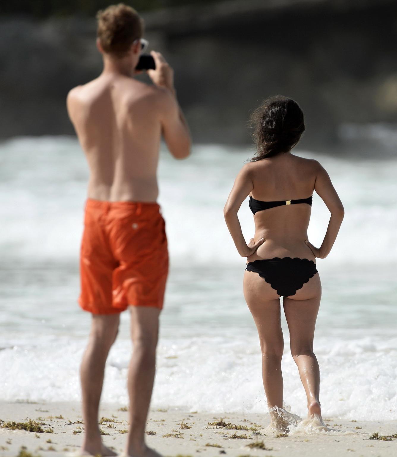 16P Rachel Bilson pregnant wearing a strapless black bikini on a beach in Barbados