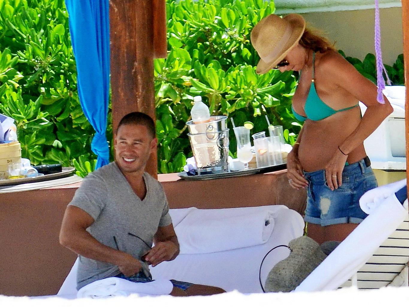 16P Stacy Keibler pregnant wearing a turquoise bikini in Mexico