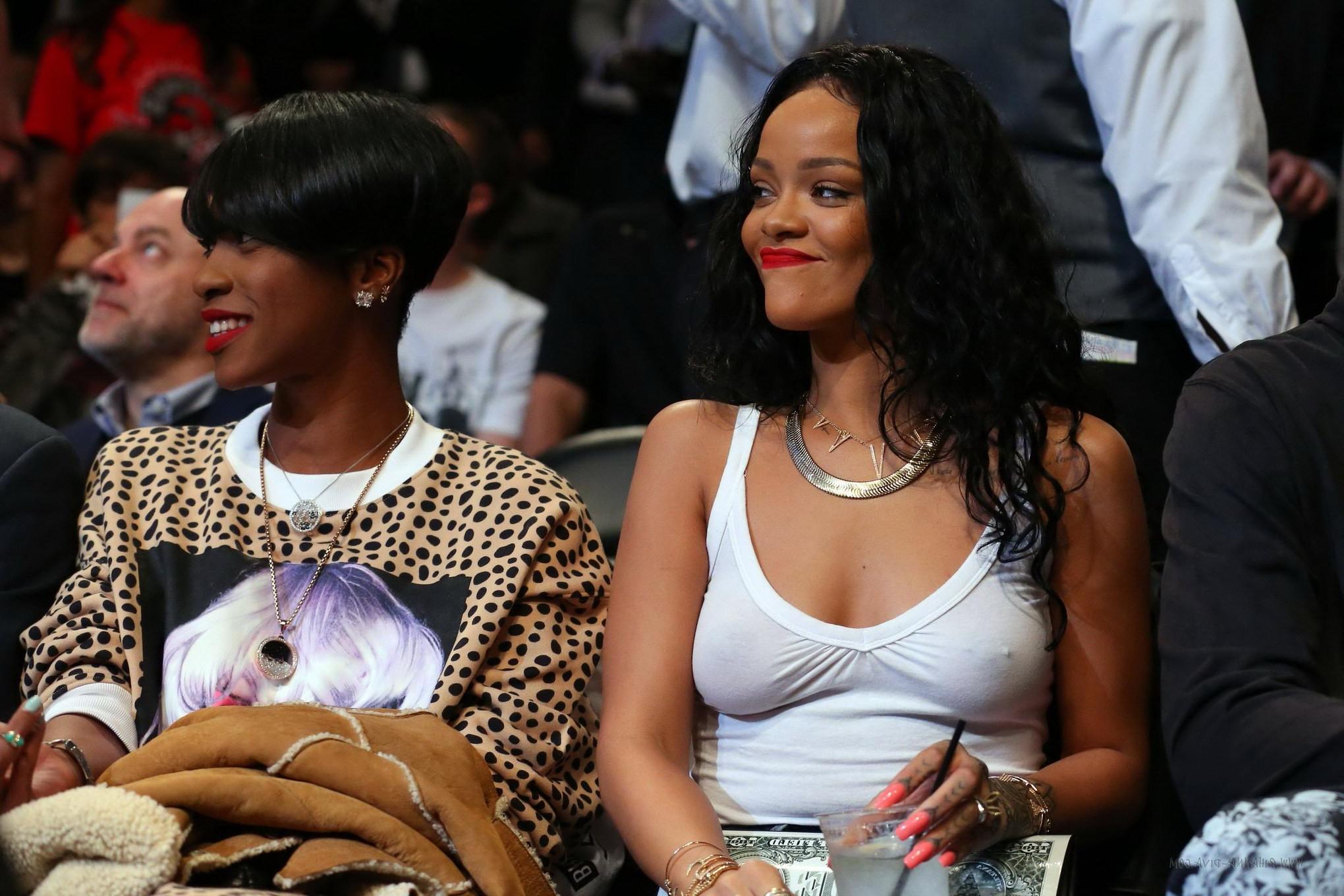 16P Rihanna shows off her boobs in seethru top at a basketball game in NYC