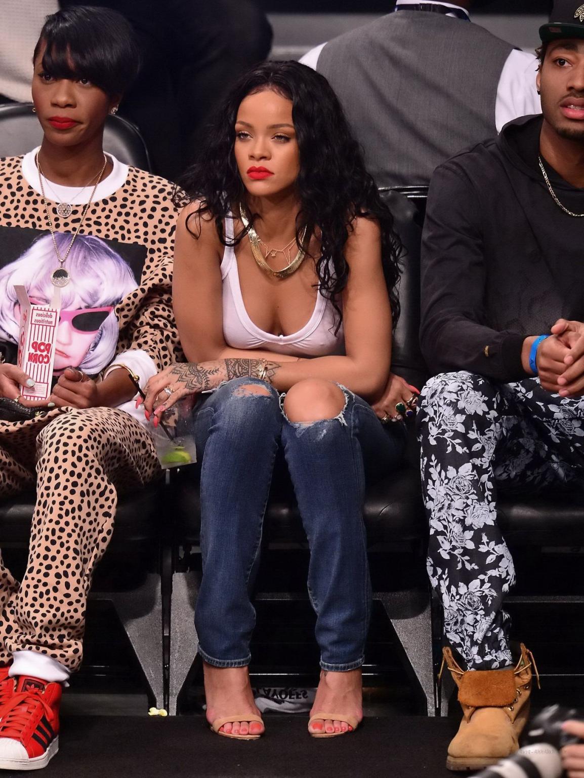 16P Rihanna shows off her boobs in seethru top at a basketball game in NYC