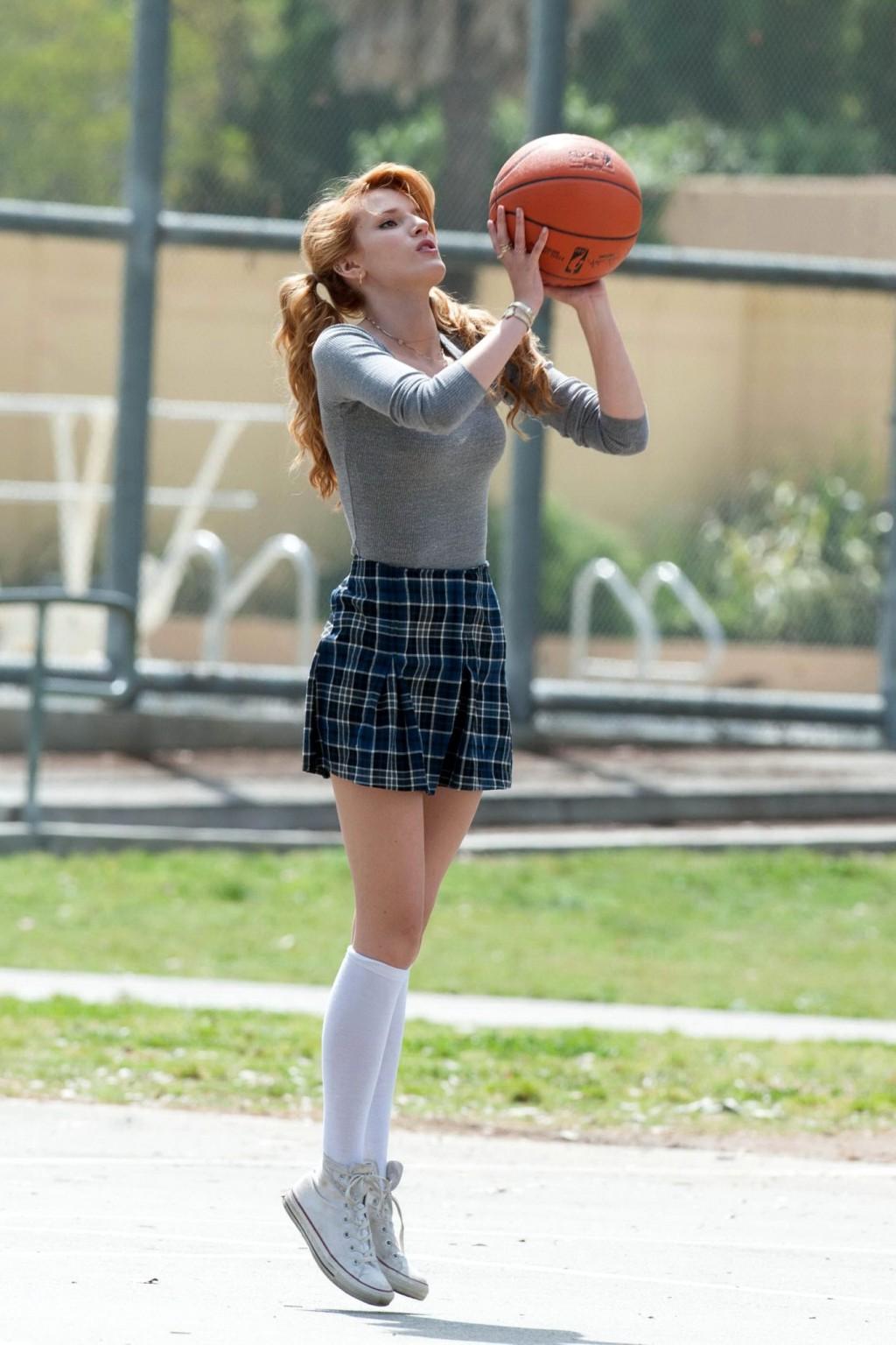 16P Bella Thorne playing basketball in a schoolgirl outfit on the set of Mostly Ghos