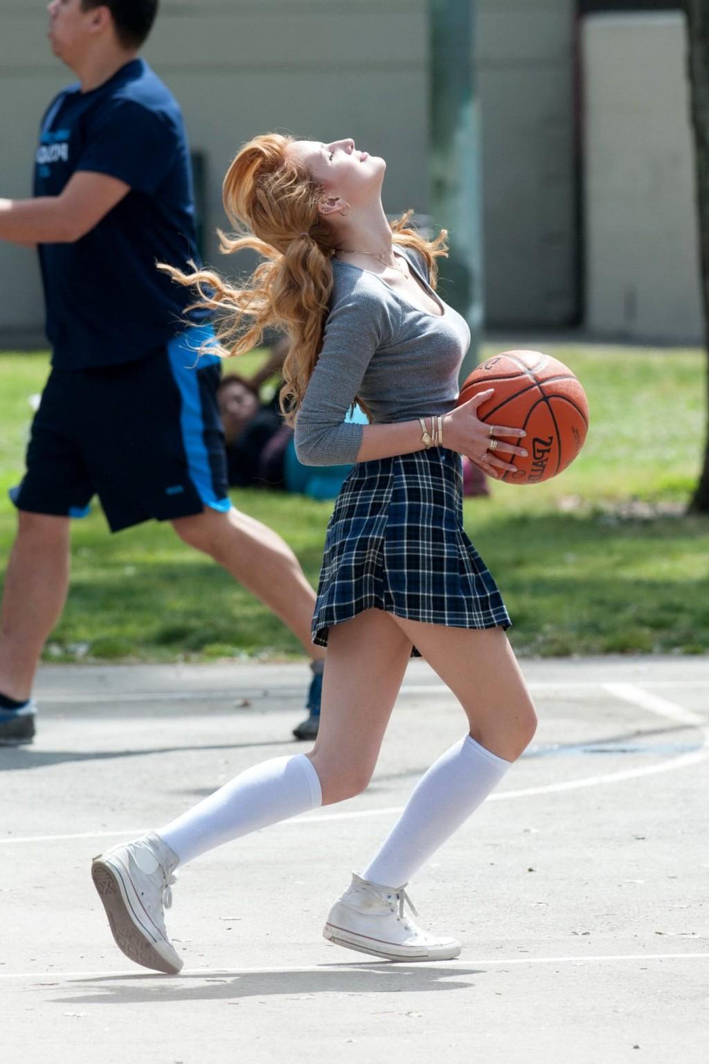 16P Bella Thorne playing basketball in a schoolgirl outfit on the set of Mostly Ghos