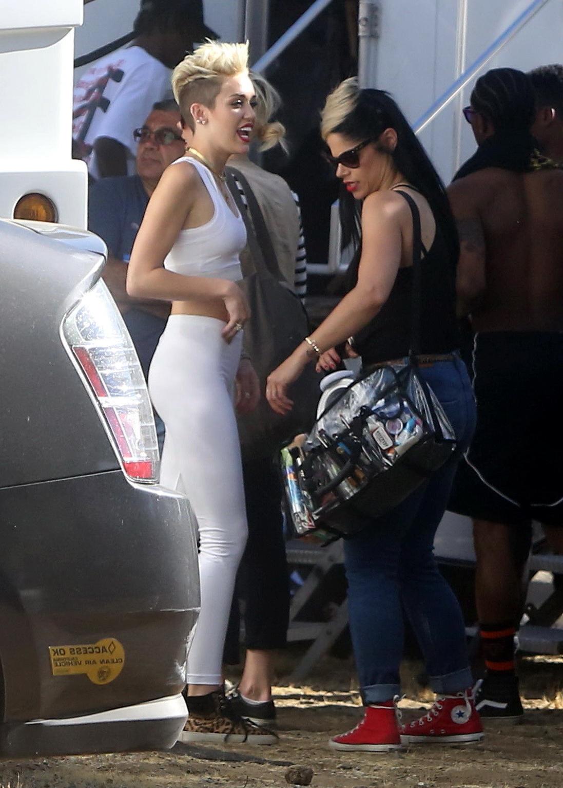 16P Miley Cyrus wearing the white tights  a sports bra on a music video set in LA
