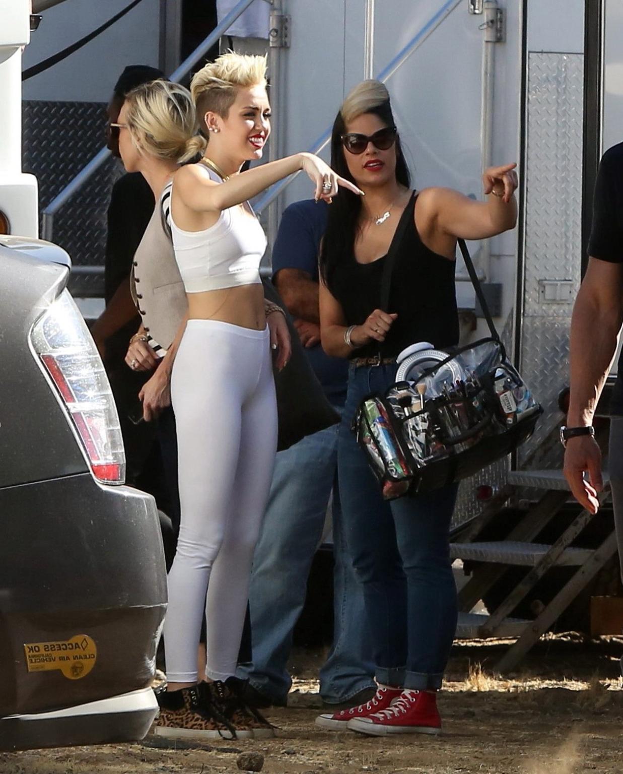 16P Miley Cyrus wearing the white tights  a sports bra on a music video set in LA