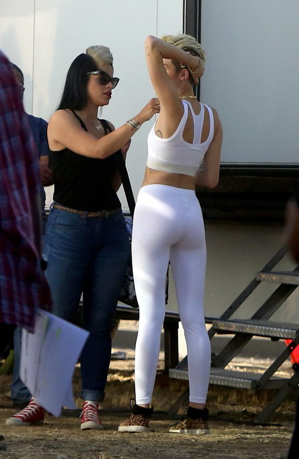 16P Miley Cyrus wearing the white tights  a sports bra on a music video set in LA
